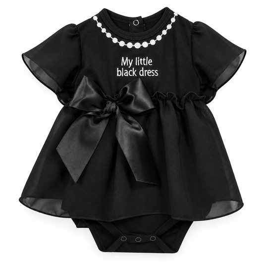 Black baby dress with white pearl-necklace print, My little black dress lettering, satin bow and sheer skirt overlay.